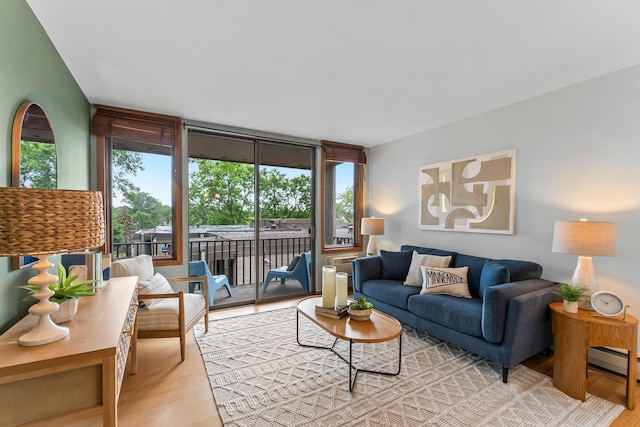 1405 40th St Unit 15F, Minneapolis, MN 55407 - living area featuring light wood-style floors and a baseboard radiator