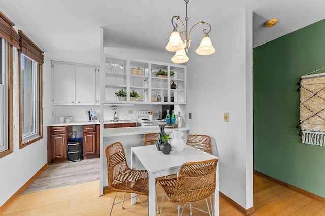 1405 40th St Unit 15F, Minneapolis, MN 55407 - kitchen featuring white stove, light wood-type flooring, light countertops, a sink, and open shelves