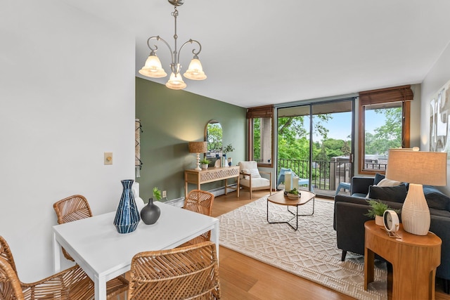 1405 40th St Unit 15F, Minneapolis, MN 55407 - living room featuring a chandelier, wood finished floors, and healthy amount of natural light