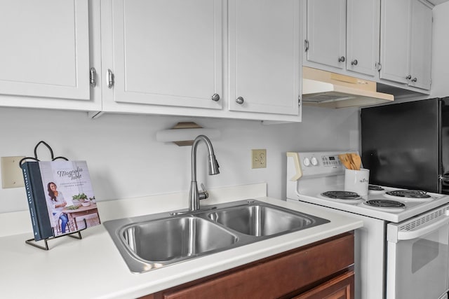 1405 40th St Unit 15F, Minneapolis, MN 55407 - kitchen featuring under cabinet range hood, white range with electric stovetop, light countertops, a sink, and white cabinetry