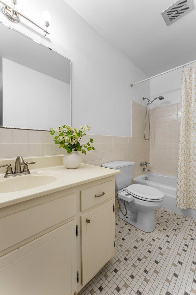 1405 40th St Unit 15F, Minneapolis, MN 55407 - bathroom featuring tile walls, vanity, toilet, shower / tub combo with curtain, and tile patterned floors