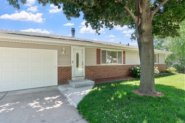 6540 Zealand Ave N, Brooklyn Park, MN 55428 - ranch-style house with brick siding, driveway, an attached garage, and a front lawn