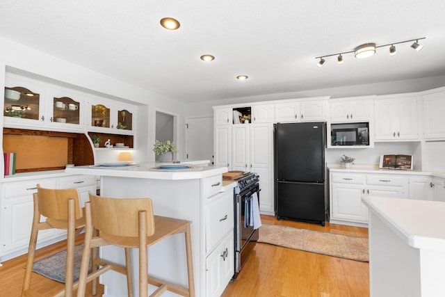 6540 Zealand Ave N, Brooklyn Park, MN 55428 - kitchen featuring black appliances, open shelves, white cabinets, a center island, and recessed lighting