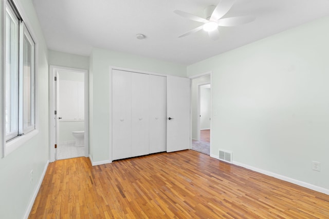 6540 Zealand Ave N, Brooklyn Park, MN 55428 - unfurnished bedroom featuring light wood-type flooring, multiple windows, and a closet