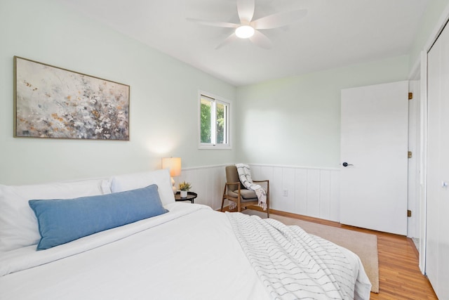6540 Zealand Ave N, Brooklyn Park, MN 55428 - bedroom featuring wood finished floors, wainscoting, and ceiling fan