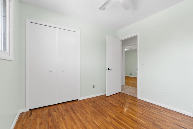 6540 Zealand Ave N, Brooklyn Park, MN 55428 - unfurnished bedroom with wood finished floors, a closet, and ceiling fan