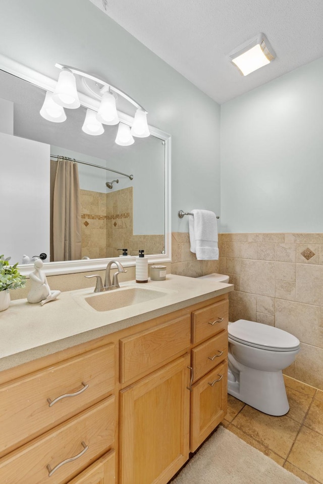 6540 Zealand Ave N, Brooklyn Park, MN 55428 - bathroom with tile walls, tile patterned floors, a shower with shower curtain, vanity, and a wainscoted wall
