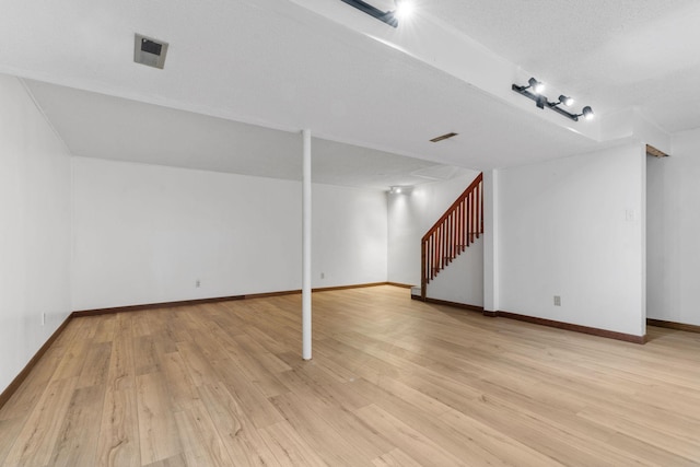 6540 Zealand Ave N, Brooklyn Park, MN 55428 - finished basement featuring light wood finished floors, stairway, and rail lighting