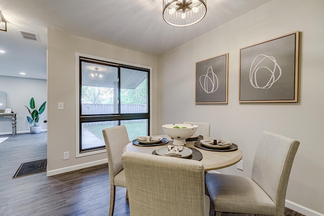 1034 Carmel Ct, Shoreview, MN 55126 - dining room with dark wood-style flooring, baseboards, and a chandelier