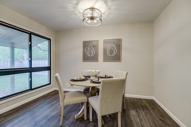 1034 Carmel Ct, Shoreview, MN 55126 - dining area with dark wood-type flooring, a chandelier, a textured ceiling, and baseboards