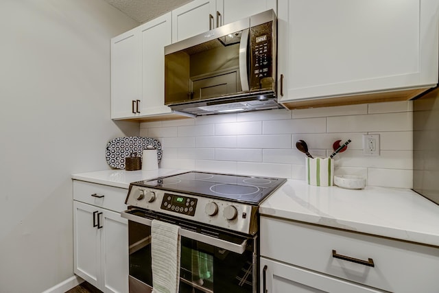 1034 Carmel Ct, Shoreview, MN 55126 - kitchen with appliances with stainless steel finishes, white cabinetry, backsplash, and light stone counters