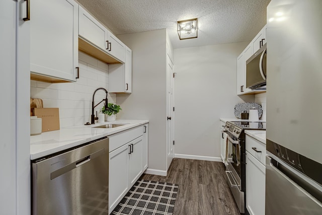 1034 Carmel Ct, Shoreview, MN 55126 - kitchen featuring appliances with stainless steel finishes, a sink, dark wood-style flooring, backsplash, and white cabinetry