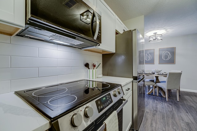 1034 Carmel Ct, Shoreview, MN 55126 - kitchen featuring electric range, tasteful backsplash, white cabinets, dark wood finished floors, and a chandelier