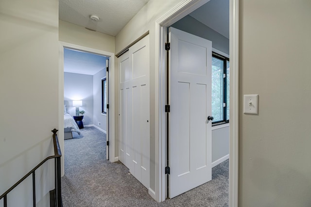 1034 Carmel Ct, Shoreview, MN 55126 - hall featuring carpet, baseboards, and a textured ceiling