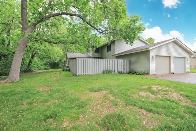 1034 Carmel Ct, Shoreview, MN 55126 - view of grassy yard with a garage