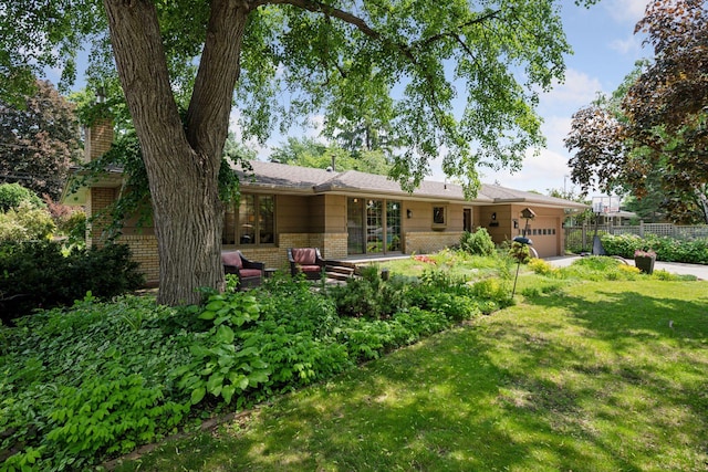 10933 Chowen Ave S, Bloomington, MN 55431 - back of house featuring brick siding, an attached garage, a chimney, and french doors