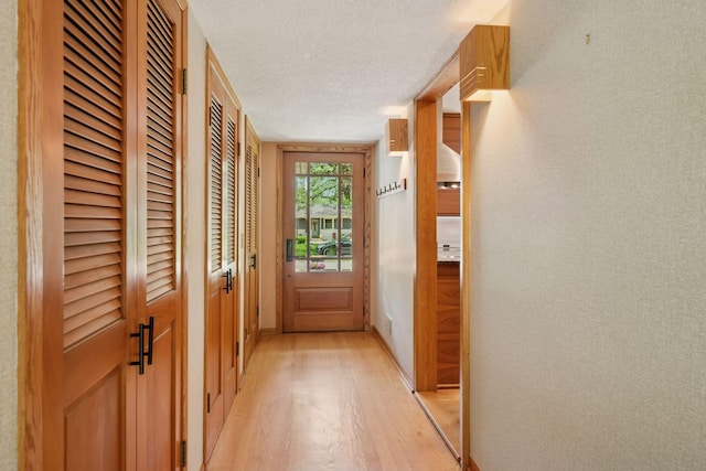 10933 Chowen Ave S, Bloomington, MN 55431 - doorway with light wood-style floors and a textured ceiling