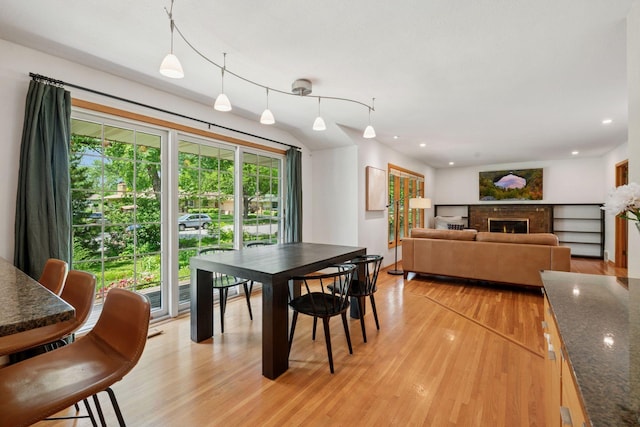 10933 Chowen Ave S, Bloomington, MN 55431 - dining space featuring healthy amount of natural light, light wood-style flooring, a warm lit fireplace, and recessed lighting