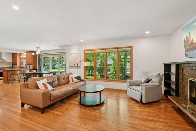 10933 Chowen Ave S, Bloomington, MN 55431 - living area with a glass covered fireplace, light wood finished floors, and recessed lighting