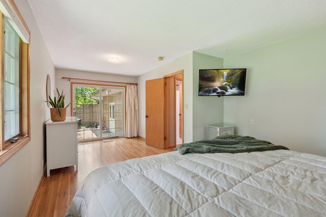 10933 Chowen Ave S, Bloomington, MN 55431 - bedroom featuring wood finished floors, access to exterior, and a textured ceiling
