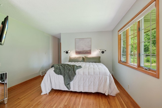 10933 Chowen Ave S, Bloomington, MN 55431 - bedroom with light wood-type flooring and baseboards