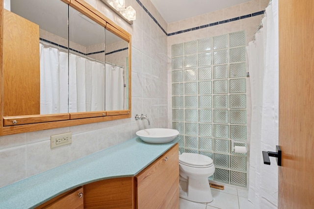10933 Chowen Ave S, Bloomington, MN 55431 - full bathroom featuring tile walls, toilet, vanity, tile patterned flooring, and a shower with curtain