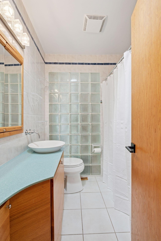 10933 Chowen Ave S, Bloomington, MN 55431 - bathroom featuring tile walls, tile patterned flooring, vanity, toilet, and a shower with curtain
