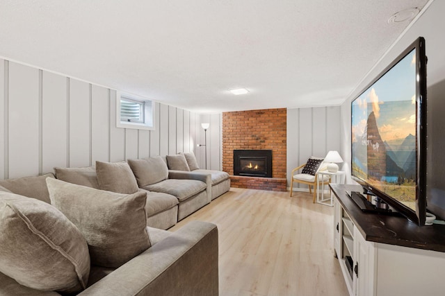 10933 Chowen Ave S, Bloomington, MN 55431 - living room with light wood-style flooring, a fireplace, and a decorative wall