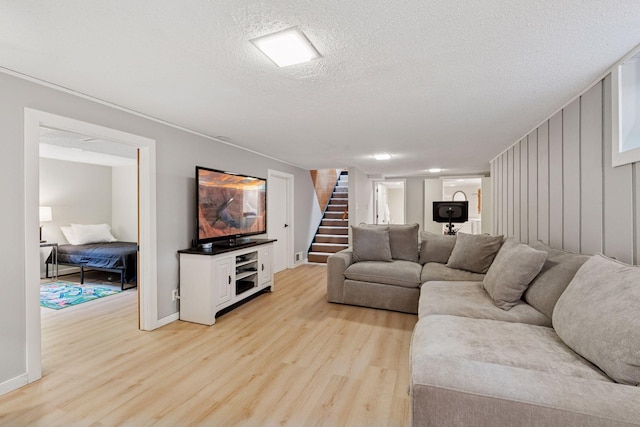 10933 Chowen Ave S, Bloomington, MN 55431 - living area featuring stairs, light wood finished floors, a textured ceiling, and baseboards