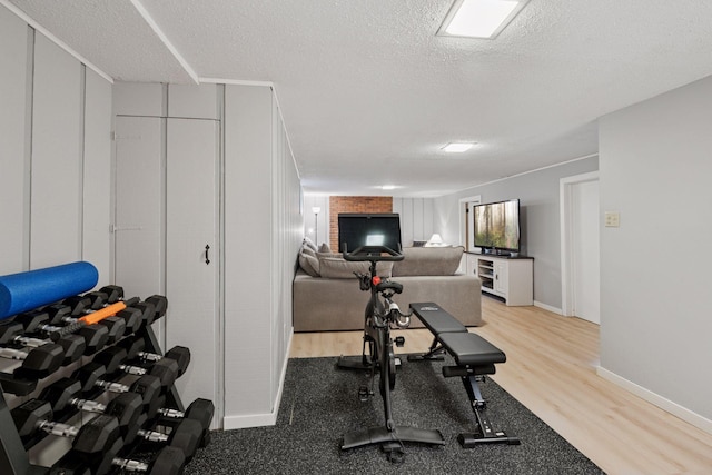 10933 Chowen Ave S, Bloomington, MN 55431 - exercise area featuring light wood finished floors, a textured ceiling, and baseboards