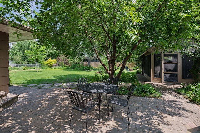 10933 Chowen Ave S, Bloomington, MN 55431 - view of patio / terrace featuring outdoor dining area and an outbuilding