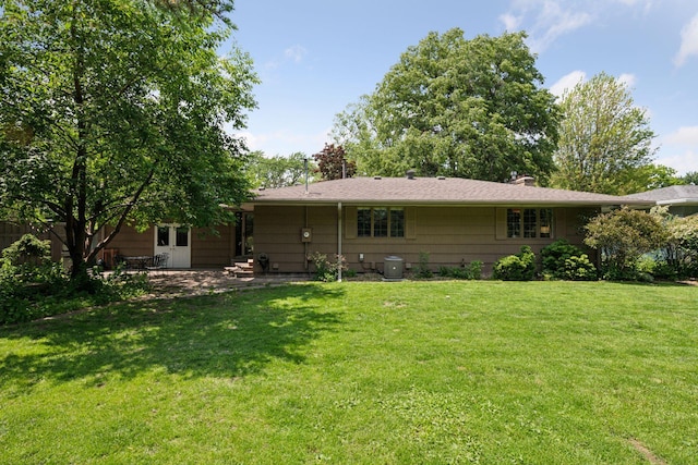 10933 Chowen Ave S, Bloomington, MN 55431 - rear view of house featuring a yard, a chimney, and a patio