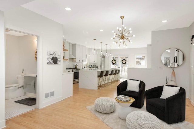 150 1st St, Excelsior, MN 55331 - living room with light wood-style flooring, a chandelier, and recessed lighting