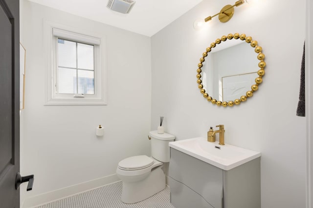 150 1st St, Excelsior, MN 55331 - half bathroom with vanity, toilet, baseboards, and tile patterned flooring