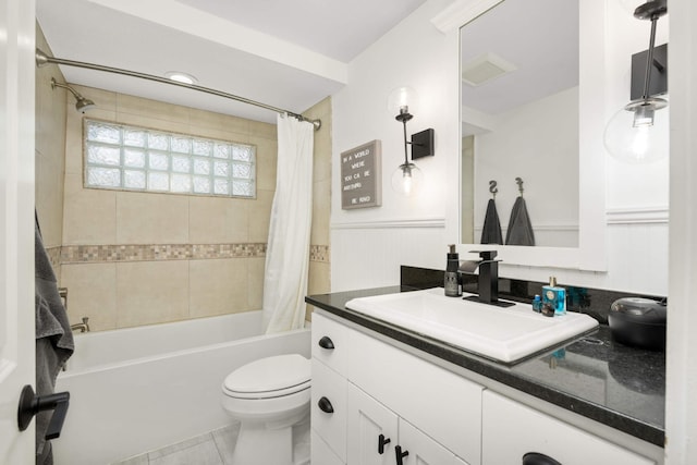 150 1st St, Excelsior, MN 55331 - bathroom featuring vanity, shower / bath combo with shower curtain, toilet, wainscoting, and tile patterned floors