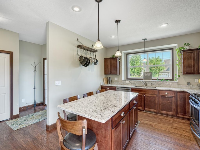 6024 158th St W, Apple Valley, MN 55124 - kitchen with a sink, dark wood-style flooring, a kitchen breakfast bar, appliances with stainless steel finishes, and light stone countertops
