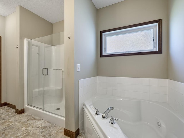 6024 158th St W, Apple Valley, MN 55124 - full bathroom with a shower stall, a tub with jets, a textured ceiling, and baseboards