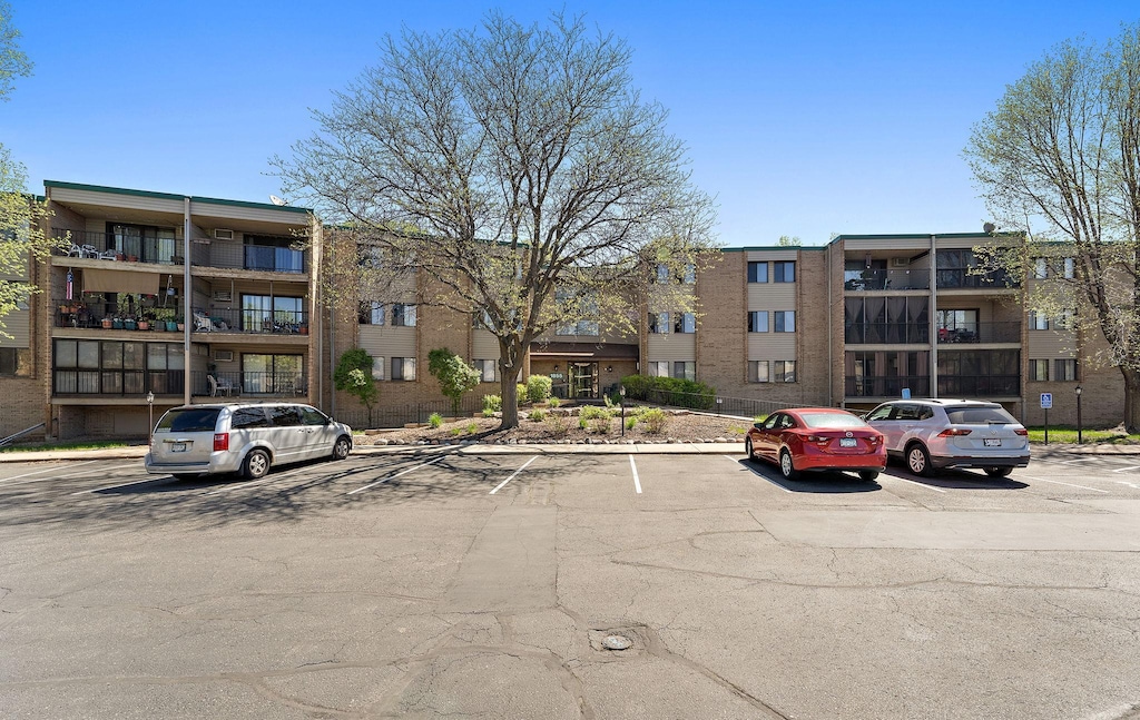 1855 Silver Bell Rd Unit 321, Eagan, MN 55122 - view of apartment building / complex featuring uncovered parking