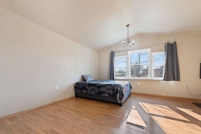 408 State St E, Grey Eagle, MN 56336 - bedroom with wood finished floors, vaulted ceiling, a chandelier, and baseboards