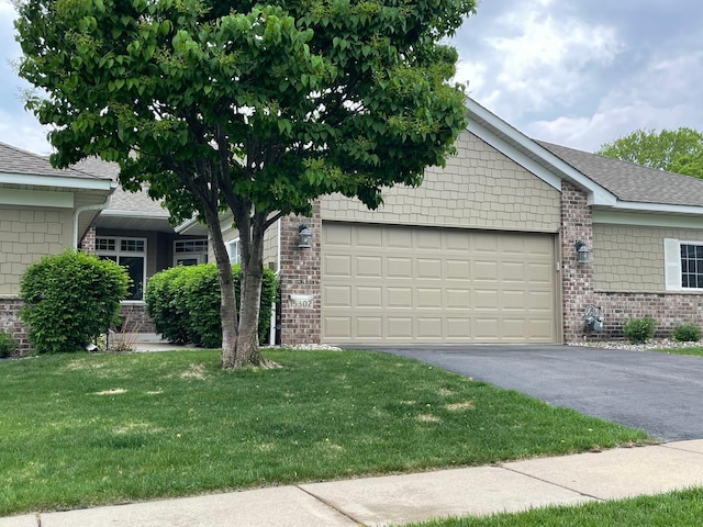15302 Jeffers Pass NW, Prior Lake, MN 55372 - ranch-style house with brick siding, asphalt driveway, a garage, a front lawn, and a shingled roof