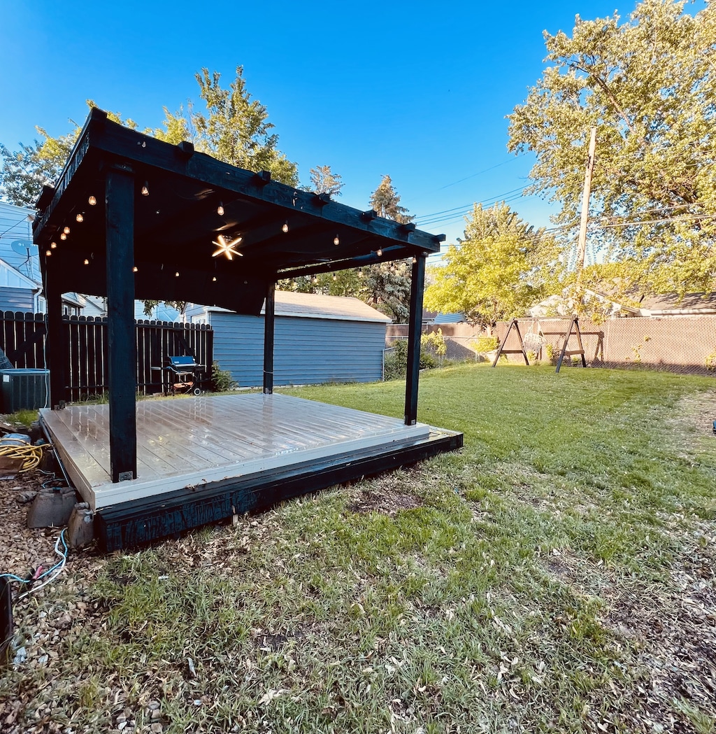 4228 Halifax Ave N, Robbinsdale, MN 55422 - view of yard with a wooden deck, ceiling fan, and cooling unit