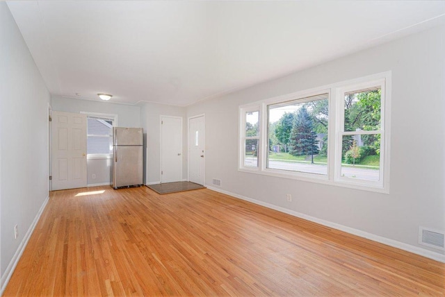 1637 37th Ave NE, Columbia Heights, MN 55421 - unfurnished living room featuring light wood-style flooring, baseboards, and plenty of natural light