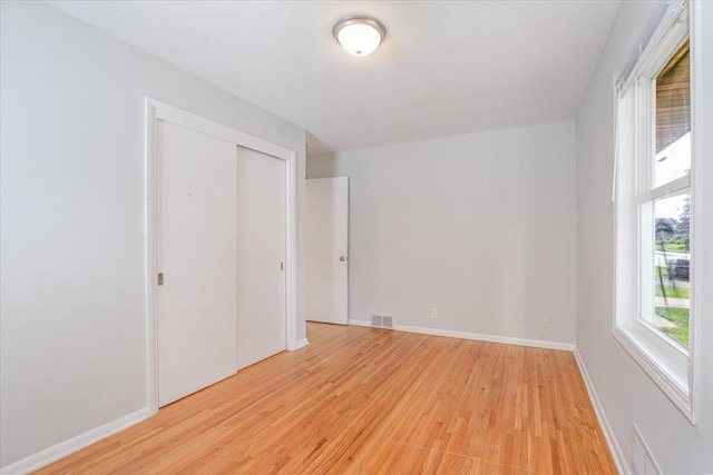 1637 37th Ave NE, Columbia Heights, MN 55421 - unfurnished bedroom with light wood-style flooring, baseboards, and a closet
