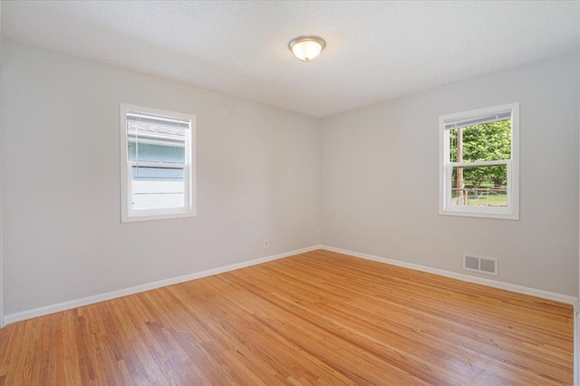 1637 37th Ave NE, Columbia Heights, MN 55421 - unfurnished room featuring light wood-type flooring, baseboards, and a textured ceiling