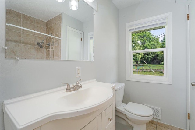 1637 37th Ave NE, Columbia Heights, MN 55421 - bathroom with toilet, vanity, a tile shower, and tile patterned floors