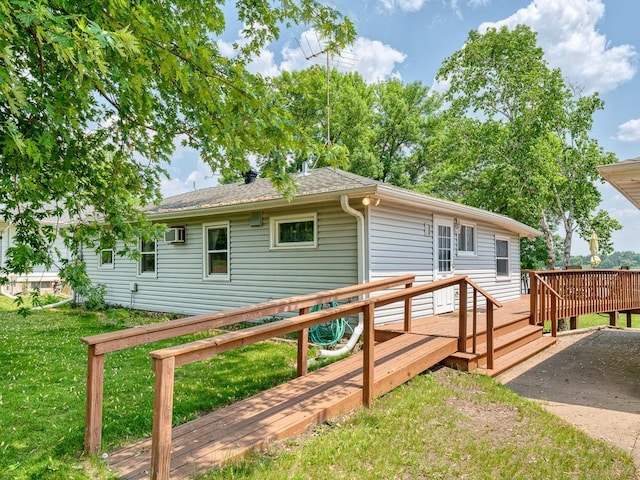 46427 Cambridge Dr, Stanchfield, MN 55080 - back of house featuring a deck, a yard, a shingled roof, and a wall unit AC