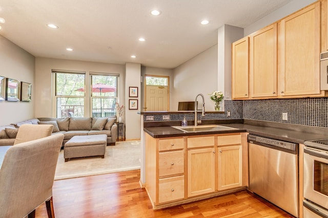 560 2nd St Unit 114, Minneapolis, MN 55401 - kitchen with appliances with stainless steel finishes, light brown cabinets, a sink, open floor plan, and recessed lighting