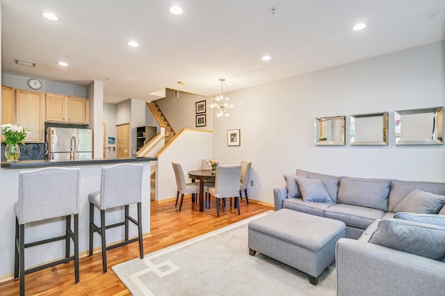 560 2nd St Unit 114, Minneapolis, MN 55401 - living area with light wood-type flooring, stairs, recessed lighting, and a chandelier