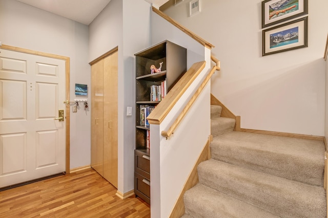 560 2nd St Unit 114, Minneapolis, MN 55401 - foyer entrance with stairs, wood finished floors, and baseboards