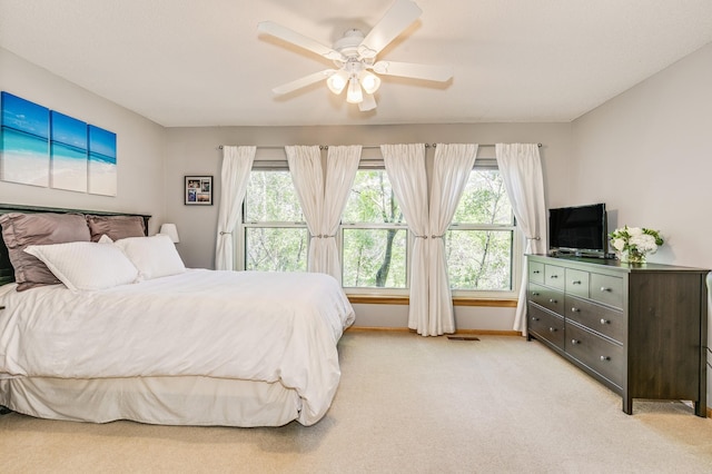 560 2nd St Unit 114, Minneapolis, MN 55401 - bedroom with multiple windows, light colored carpet, a ceiling fan, and baseboards